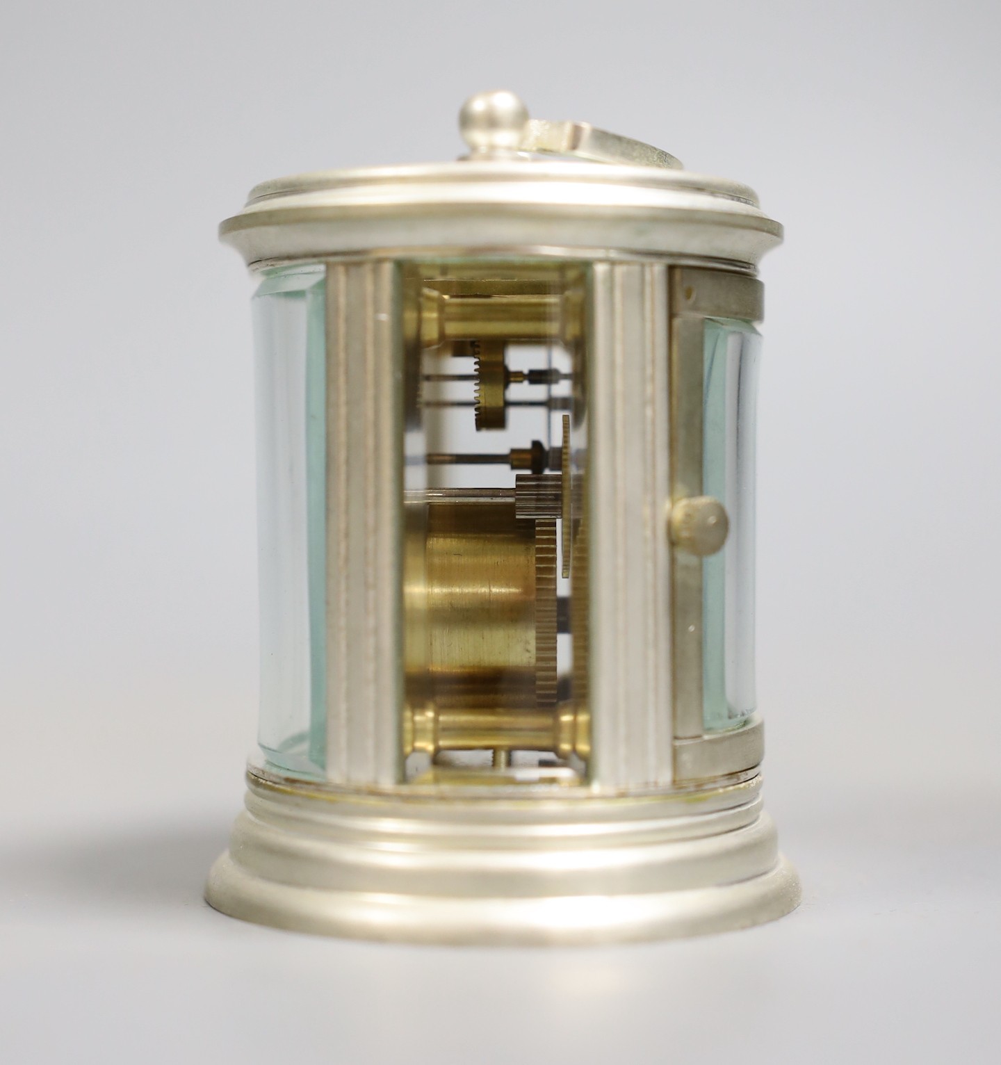 A circular plated carriage clock with key and a Victoria Cross gent's wristwatch